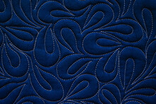 Close Up Texture Of Quilting By Free-motion Machine Technique. On Dark Blue Clothes Background