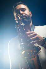 Man Playing Saxophone On Stage During Concert