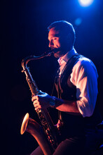Bearded Male Musician Playing Saxophone On Stage