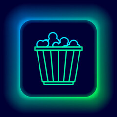 Poster - Glowing neon line Popcorn in cardboard box icon isolated on black background. Popcorn bucket box. Colorful outline concept. Vector