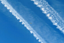 Plane Crossing The Sky Between Two Chemtrails.