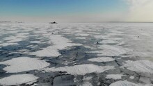Winter Fishing Near Kronshtadt City Saint-Petersburg. Gulf Finland Cracked Ice. Snow Dunes Footprints. Aerial View. Flying Over. Drone Moving Forward. High Quality 4k Footage. High Quality 4k Footage