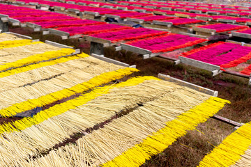 Wall Mural - China Fujian Province Dapu Yongchun. Incense sticks are spread on racks to dry at the incense factory.