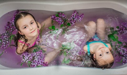 Wall Mural - little sisters in the bathroom with flowers