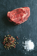 Raw steak on the table
Cooking. Raw piece of steak on the table with piece of rosemary
