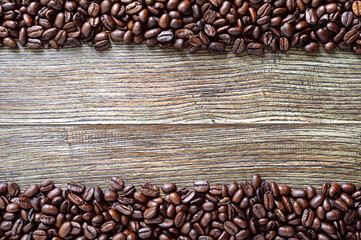 Coffee beans on a wooden background. The top view. flat lay. Copy space for an inscription.