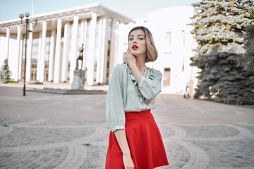 cute blonde girl in red skirt outdoors posing walk