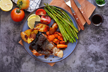 Grilled Salmon with Sauce, Carrots, Potatoes, Asparagus, Tomatoes, Lemons Healthy Food