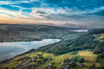 drone view over a landscape with lakes and the alps 