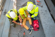 © VStudio - Construction worker has an accident at a construction site. Emergency help engineers provide first aid to construction workers in accidents. Safety team help a construction worker who has an accident.