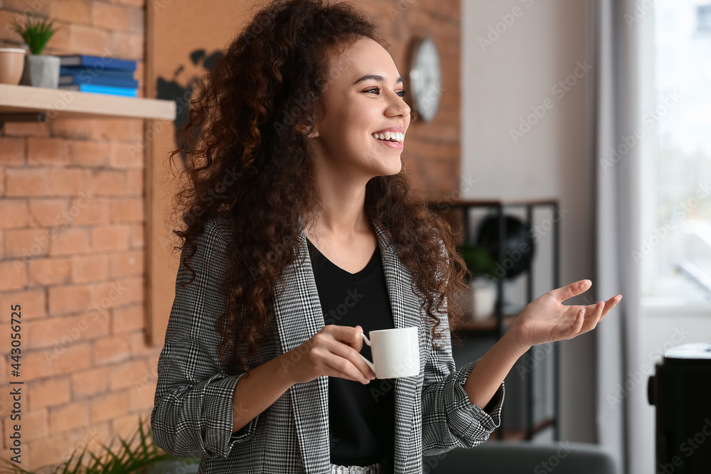 Beautiful young woman with cup of coffee at home - obrazy, fototapety, plakaty 