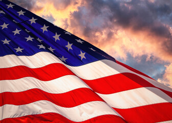 American flag waving in the wind at sunset.