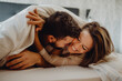 © ADDICTIVE STOCK - Happy couple hugging on bed