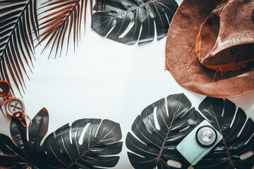 Fototapete - Tropical leaves, cowboy hat, compass, old flashlight, retro style, minimal layout, travel concept, blank white background, surreal color