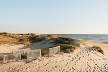 A Sandy Beach With A White Fence, Outer Banks, North Carolina