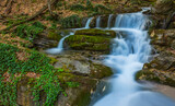 Fototapeta Łazienka - closeup blue waterfall rushing through mountain canyon