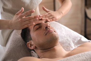 Canvas Print - Man receiving facial massage in beauty salon