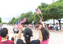 Diverse People Waving American Flag On Independence Day Street Parade Celebration
