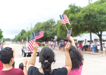 Diverse people waving American flag on Independence Day Street Parade Celebration