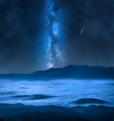 Wall Mural - milky way over foggy walley in tatra mountains.
