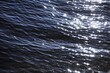 Trail of the sun glitters on the water.