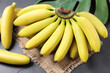 © New Africa - Tasty ripe baby bananas on dark table