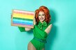 Happy drag queen celebrating gay pride holding banner with rainbow flag symbol of LGBTQ community