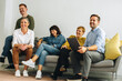 © Jacob Lund - Happy creative team sitting in lobby