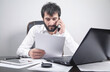 © andranik123 - Man reading document in office. Business
