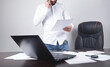 © andranik123 - Man reading document in office. Business