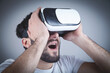 © andranik123 - Surprised man wearing virtual reality goggles.