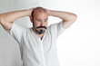 © Valoa Studio - Caucasian man surprised, receiving bad news, dressed in white on white isolated background
