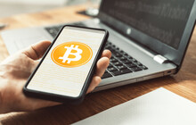 Man Use Smartphone Online Pay With Bitcoin On Laptop