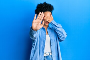 Poster - Young african american girl wearing casual clothes covering eyes with hands and doing stop gesture with sad and fear expression. embarrassed and negative concept.