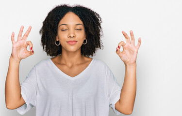 Poster - Young african american girl wearing casual clothes relax and smiling with eyes closed doing meditation gesture with fingers. yoga concept.