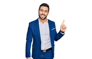 Sticker - Young hispanic man wearing business jacket with a big smile on face, pointing with hand finger to the side looking at the camera.