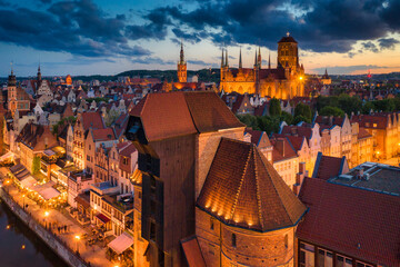 Amazing architecture of the main city in Gdansk at dusk, Poland. Aerial view of the historical Port Crane at the Motlawa river