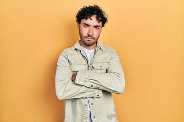 Canvas Print - Young hispanic man wearing casual clothes skeptic and nervous, disapproving expression on face with crossed arms. negative person.