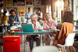 © luckybusiness - Elderly female boss and her young female colleagues are chatting while enjoying a break at office. Employees, office, work