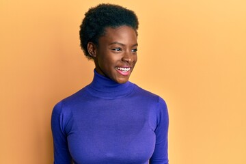 Poster - Young african american girl wearing casual clothes looking to side, relax profile pose with natural face and confident smile.