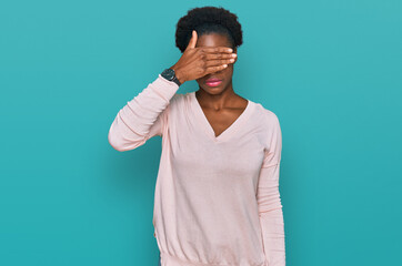 Sticker - Young african american girl wearing casual clothes covering eyes with hand, looking serious and sad. sightless, hiding and rejection concept