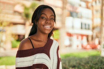 Young african american woman smiling happy standing at the park.