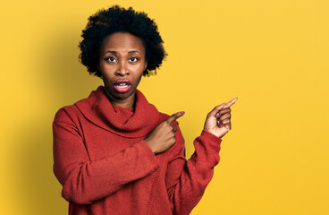 Sticker - African american woman with afro hair pointing with fingers to the side in shock face, looking skeptical and sarcastic, surprised with open mouth