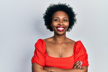 Sticker - Young african american woman wearing casual clothes happy face smiling with crossed arms looking at the camera. positive person.