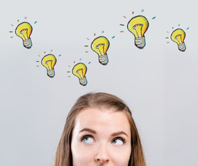 Wall Mural - Light bulbs with young woman