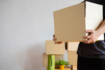 House moving concept. Man holding cardboard box