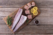 Raw hake on wooden background
