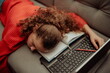 © Minet - Tired girl is sleeping next to a laptop.Tired girl from distance learning at home.Online education for kids during quarantine.