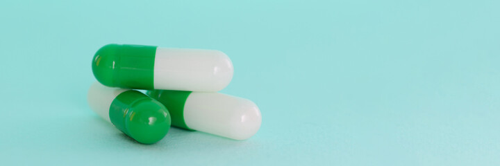 Sticker - White-green pills on blue background. Development of the pharmaceutical industry