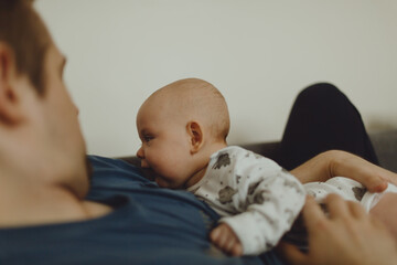 baby lies on the chest of dad